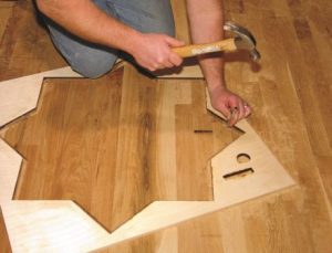 Photo 5: If you expose nails on any pass, use a nail set to drive the nail further into the floor and out of the way of the router bit.