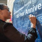 Fishman’s Nicole Robinson adds her signature to the celebratory banner, which will be on permanent display at Fishman’s Baltimore headquarters.
