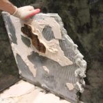 Stone slab was spot set leaving voids under the tile