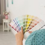 Female interior designer with color palette samples indoors