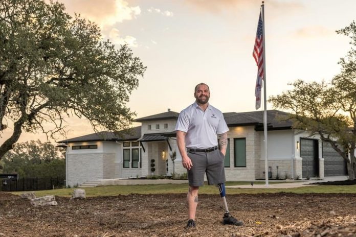 Capt. Carver in front of his new R.I.S.E. home