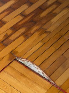 Moist, swollen and receding parquet after week outfall water from corroded water heater