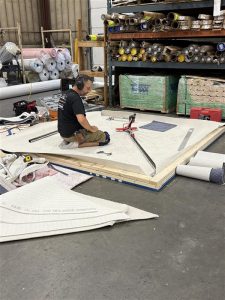 Lamos Jr working on his carpet installation TISE Boston regional