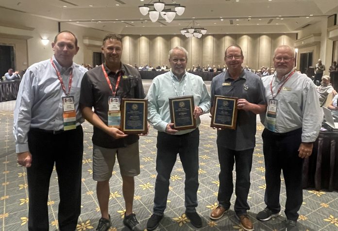 NTCA Technical Committee award recipients flanked by the committee's chair and co-chair.