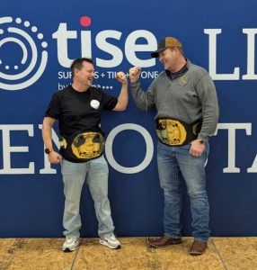 Salisbury and Lewis celebrate while wearing their championship belts.