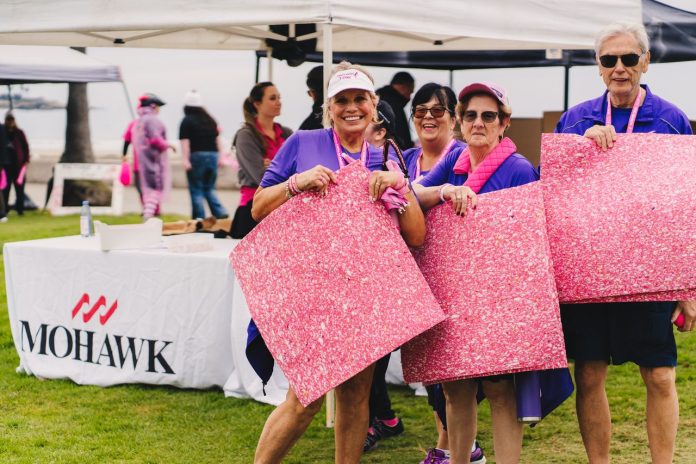 Participants hold pink Mohawk SmartCushion during a Susan G. Komen 3-Day Series last year in San Diego.
