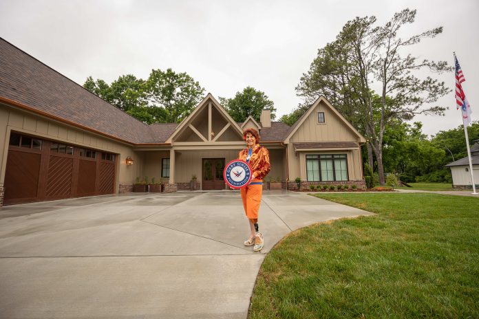 U.S. Army Cpt. Leslie Nicole Smith in front of her new R.I.S.E. home in Nashville.